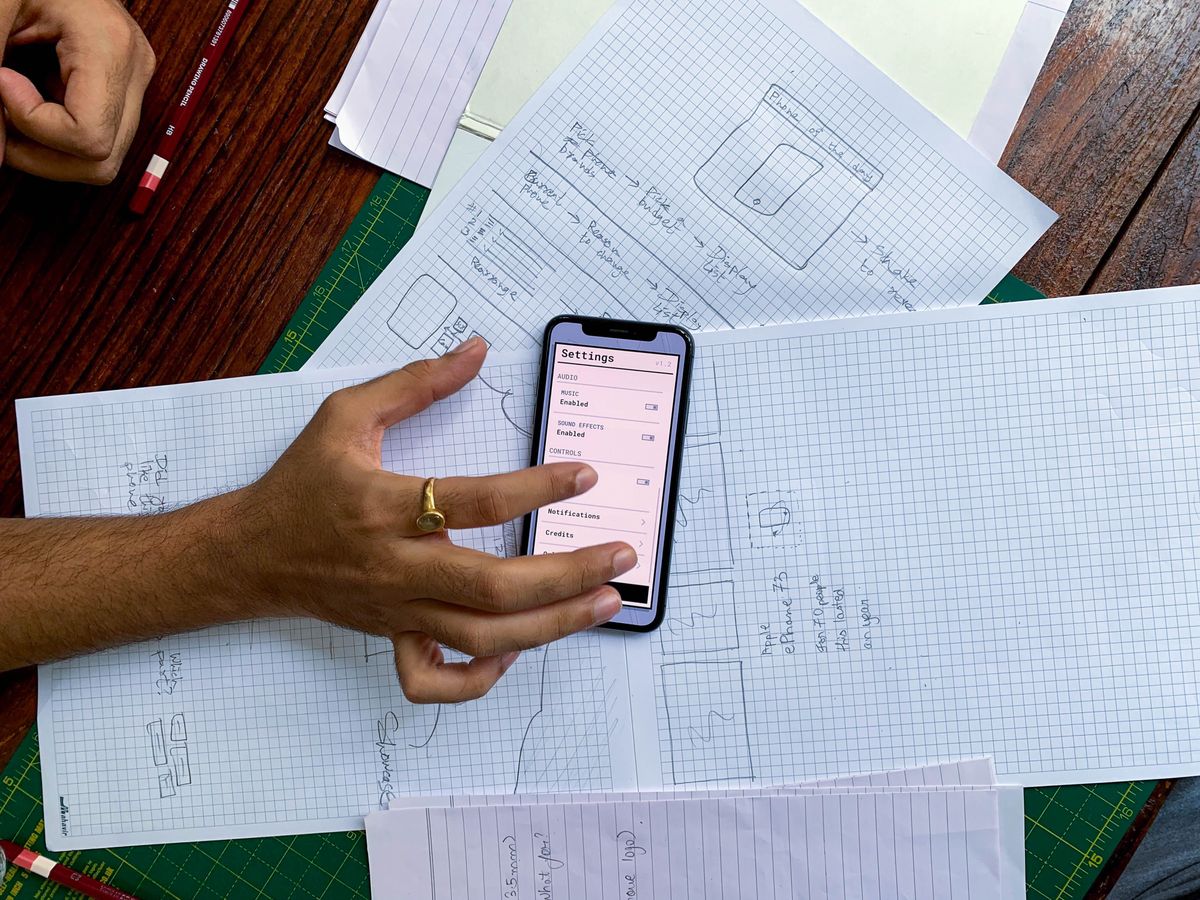 Houston business team reviewing smartphone app screens during a product planning meeting