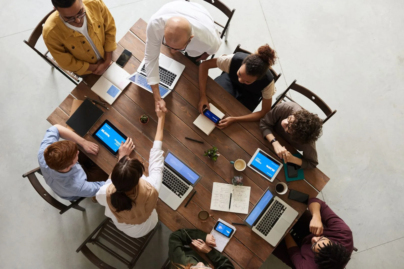 Small business team reviewing ChatGPT workflow plans on laptops in a modern office