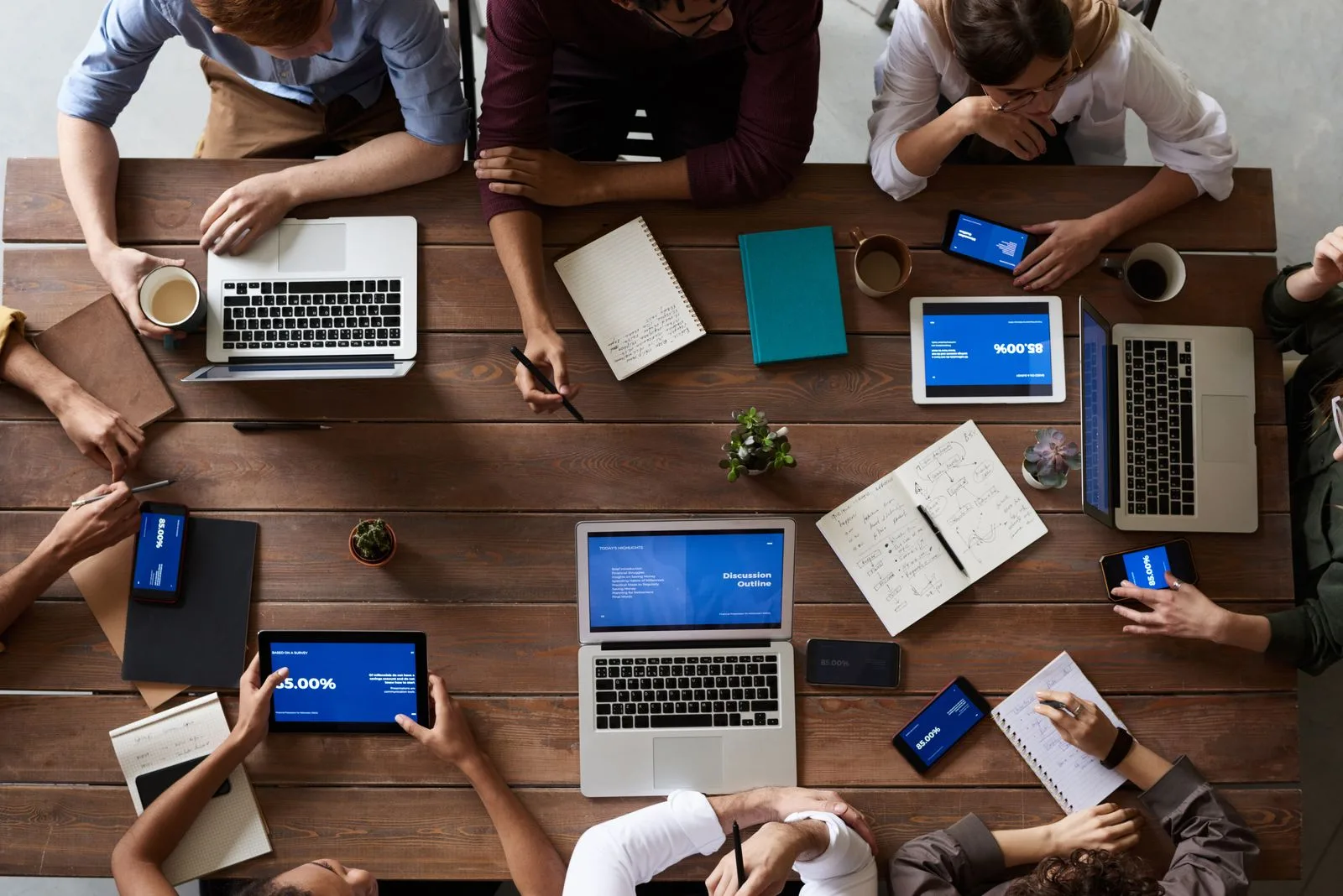 Product team and business leaders reviewing custom mobile app development scope, budget, and launch plan in a collaborative office meeting