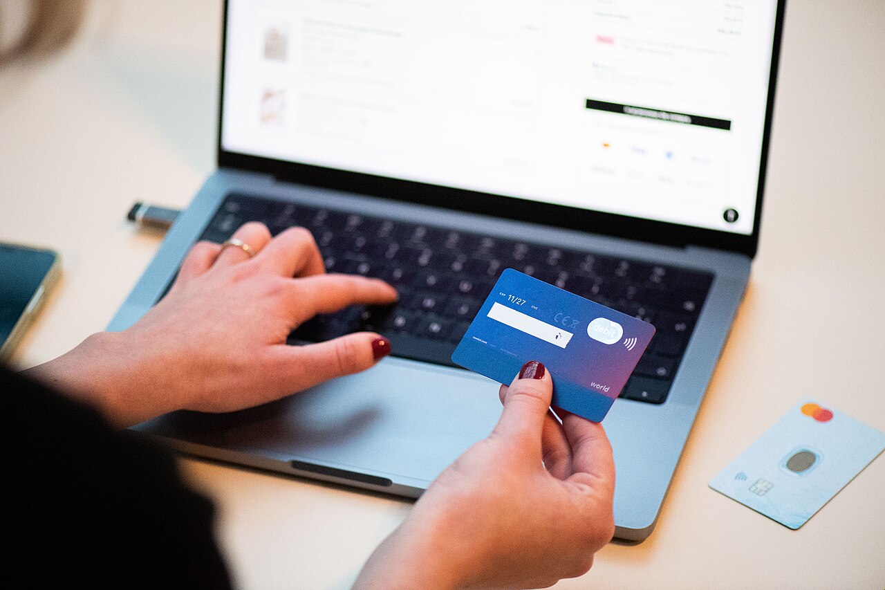Laptop displaying online shopping checkout with a bank card for ecommerce website development