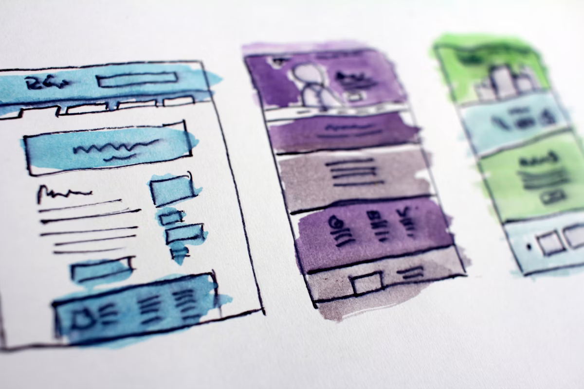 Product design team reviewing app wireframes and interface flows