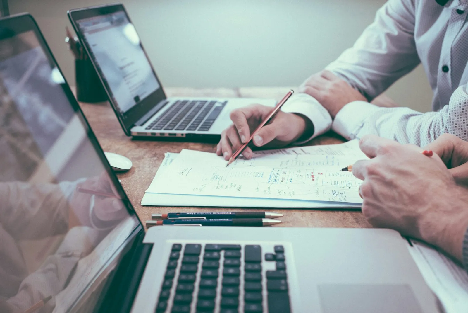 Small business owner reviewing website maintenance tasks and performance reports on a laptop