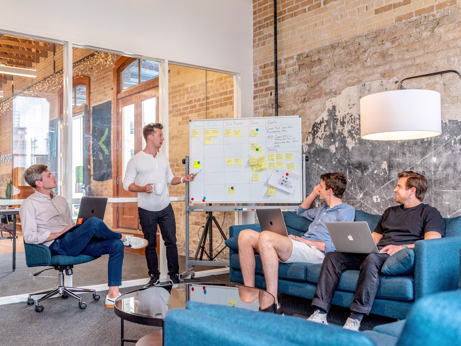 Business team reviewing CRM records, website leads, and workflow notes in a strategy meeting