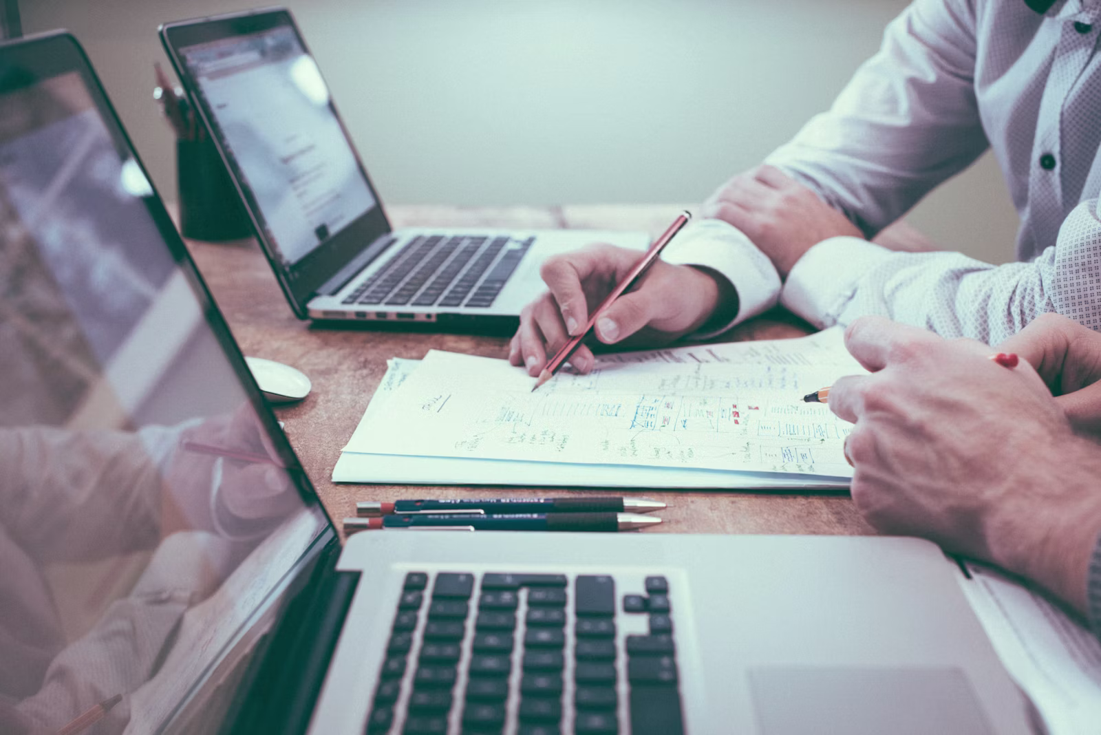 Small business owner reviewing website maintenance tasks and performance reports on a laptop