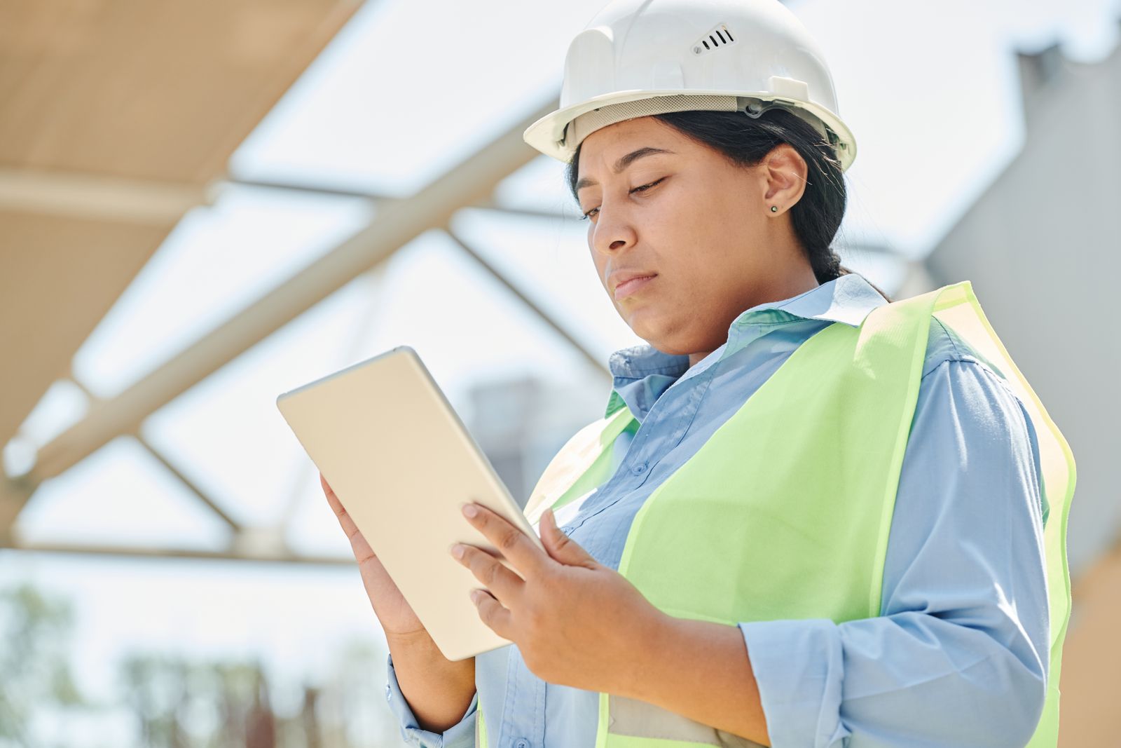 Engineer using a digital tablet while reviewing field service operations