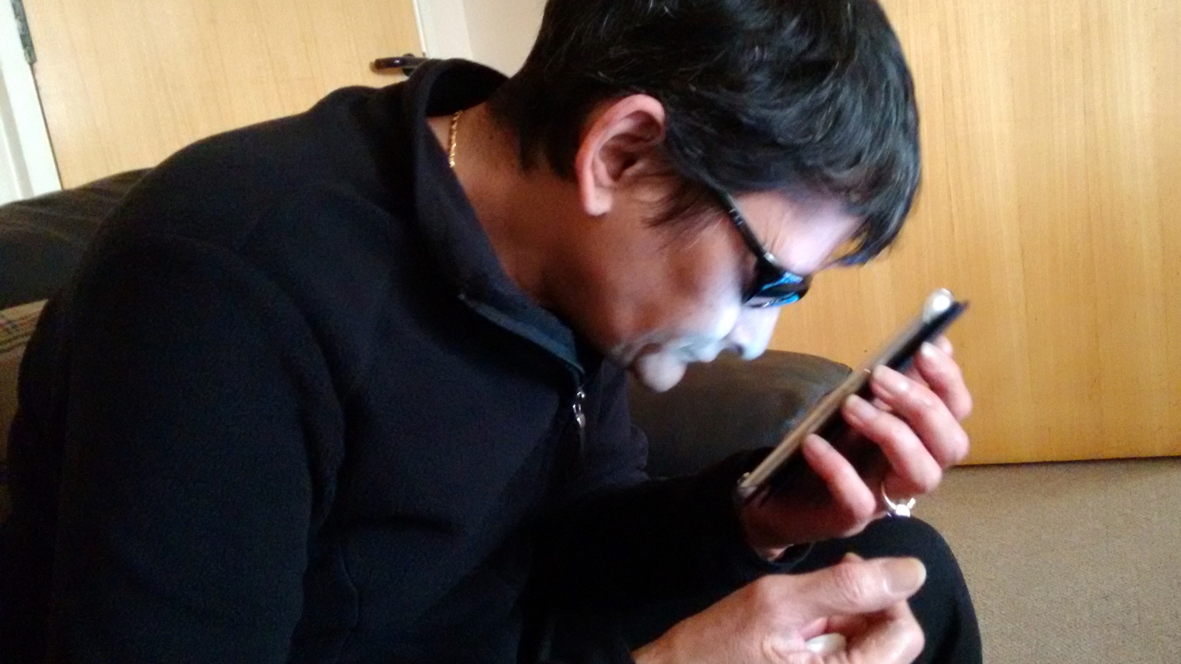 Low-vision user looking closely at an Android mobile phone screen