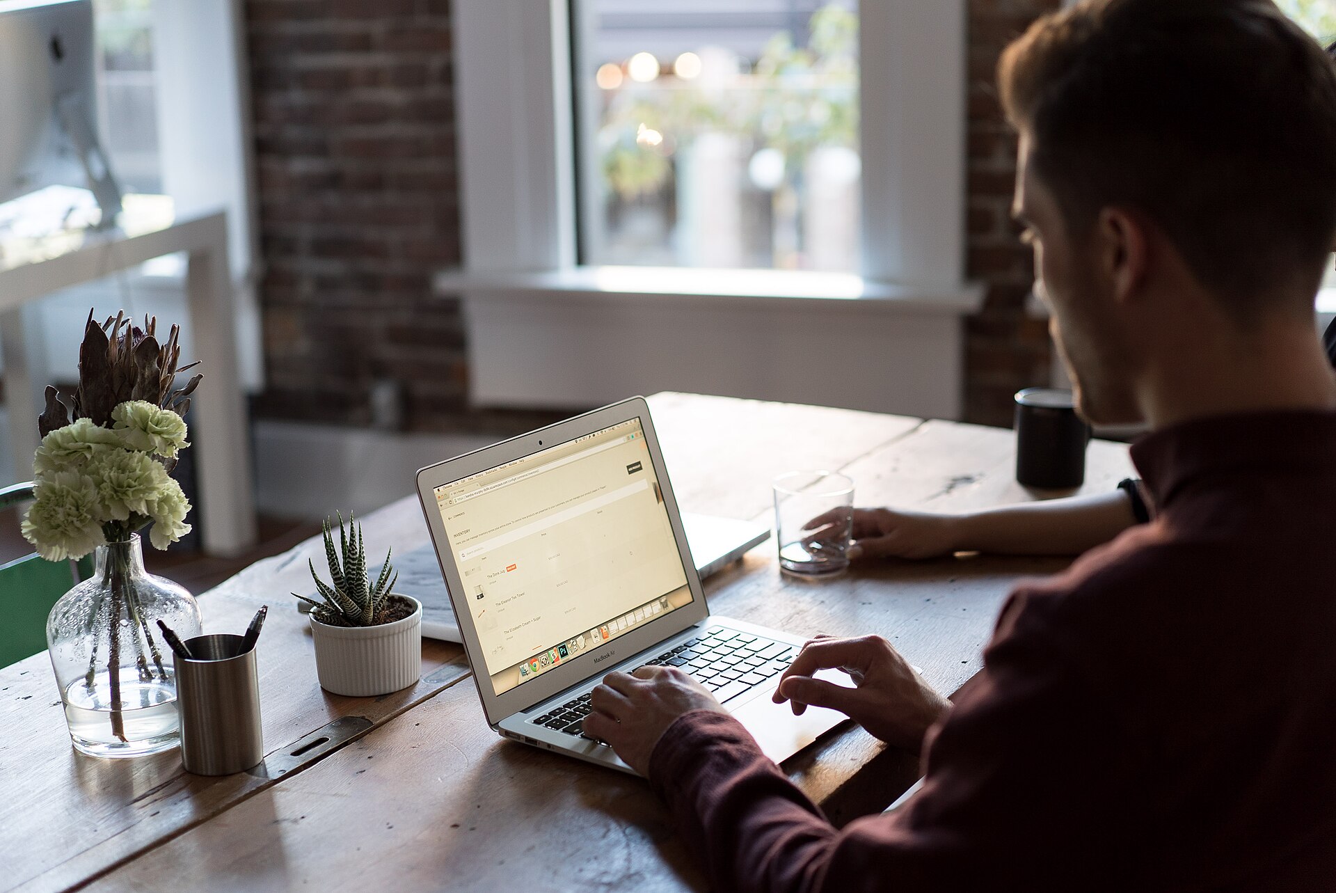 Business professional using a laptop while evaluating WordPress software options