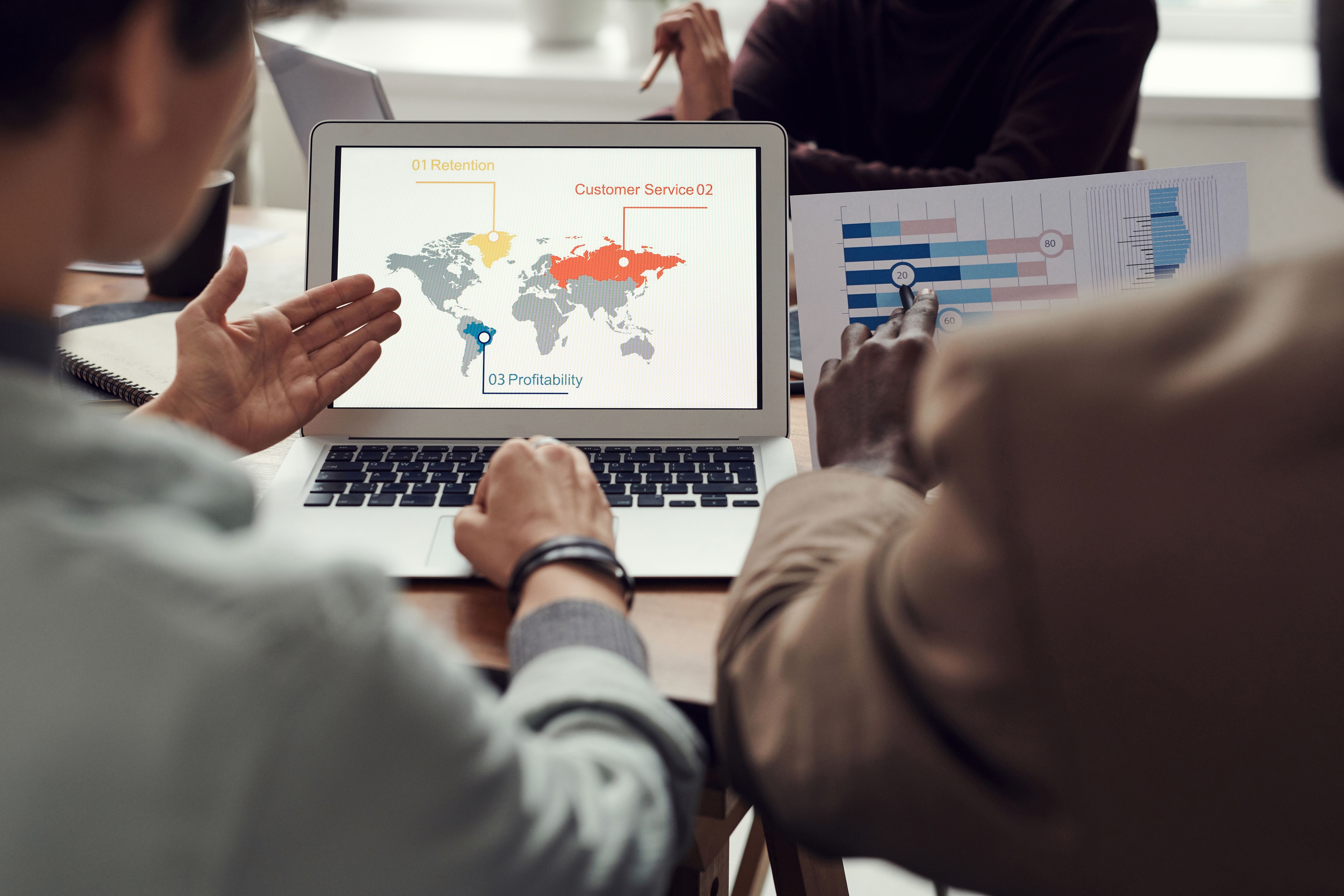 Business team reviewing customer data and CRM workflows on a computer