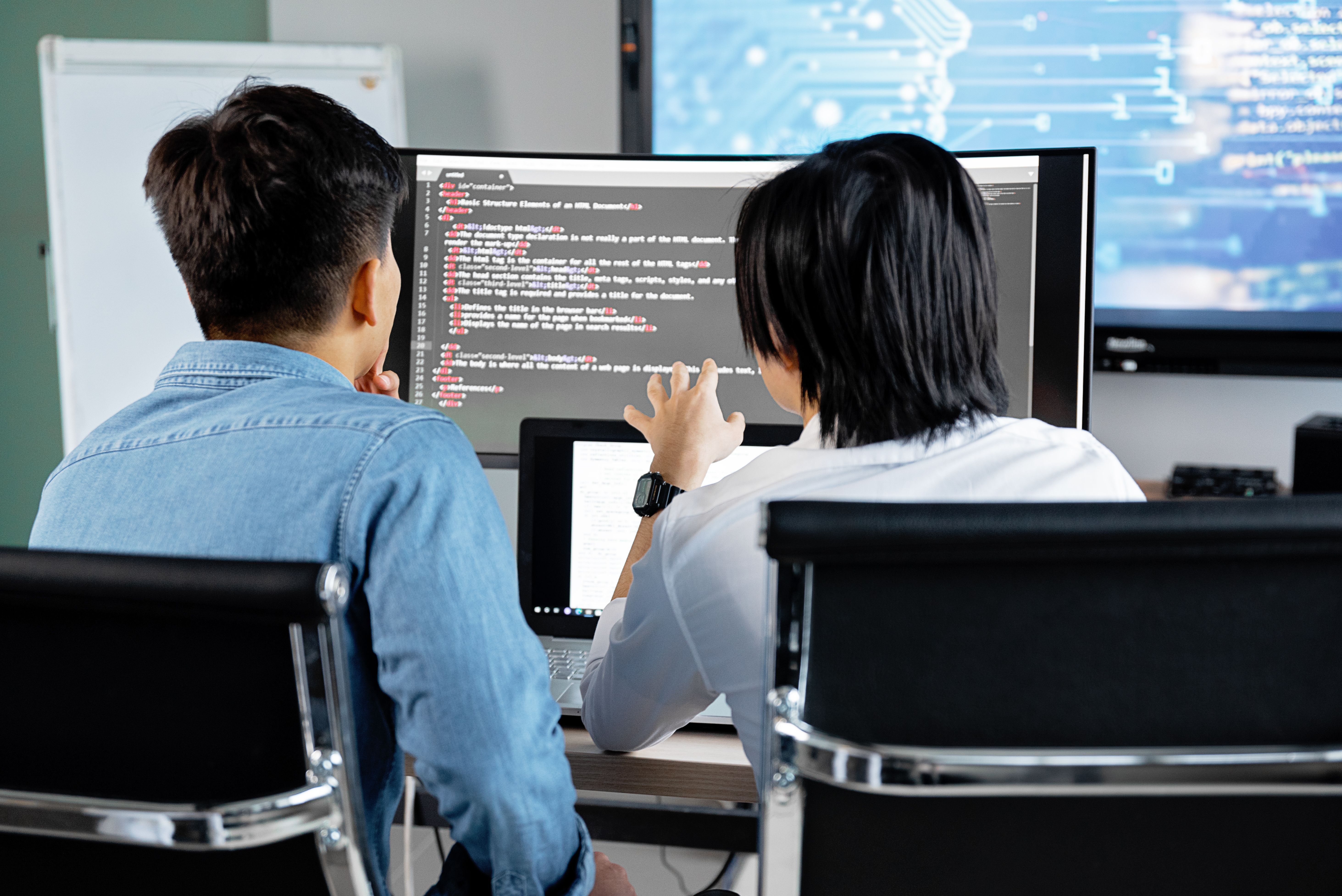 Two developers reviewing a WordPress website before launch
